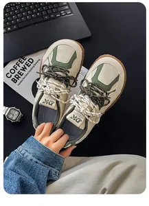 Close-up of retro beige and green men's sneakers with wide toe and thick sole design.