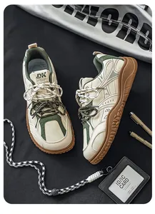 Detailed view of retro beige and green men's sneakers with thick brown soles on black background