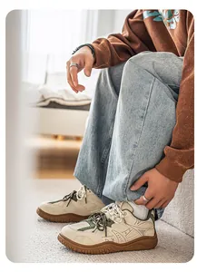 Detail side view of stylish men's retro beige sneakers with thick soles on a model