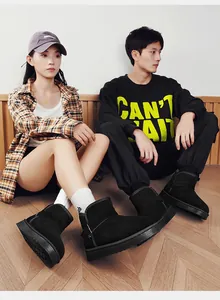 Couples wearing stylish black winter snow boots with warm fleece lining indoors