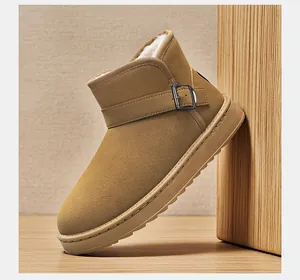 Detailed view of tan snow boot with buckle strap and plush faux fur lining.