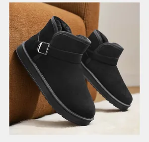 Close-up detail of black winter snow boots with warm plush lining and silver buckle strap