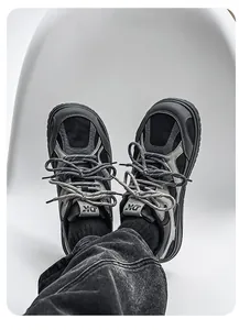 Detailed top view of retro black and grey chunky sneakers for men on a white chair