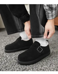 Detailed shot of black fleece-lined men's winter clog shoes with a metal buckle