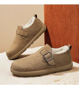 Detailed macro view of brown suede winter clogs with warm white fleece lining and buckle strap.