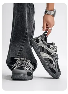 Close-up of retro chunky sneakers with thick sole and multi-textured grey-black design