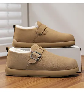 Close-up of tan suede men's winter loafers with warm white faux fur lining and buckle