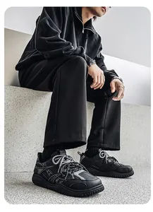 Close-up of black retro chunky sneakers with thick anti-slip soles on model