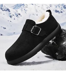 Side view of black fleece-lined men's clog shoes with buckle in winter snow setting
