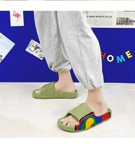 Close-up of light green slides featuring a textured strap and colorful wavy side details