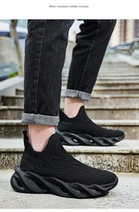 Dettaglio ravvicinato di scarpe sportive nere fly-knit con suole in gomma su scale.
