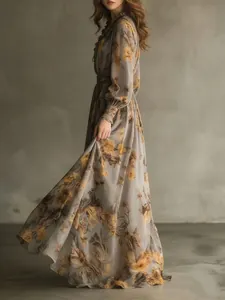 Elegant flowing detail of vintage floral chiffon maxi dress in grey with yellow prints