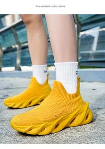 Vista dettagliata delle sneaker gialle traspiranti in fly-knit con spessa suola in gomma