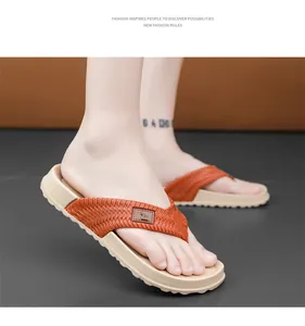 Close-up of men's flip-flops with woven orange straps and thick beige soles