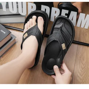 Detailed view of black men's flip-flops with textured straps and comfortable thick soles