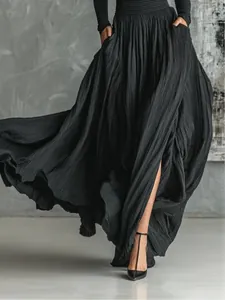 Detailed view of the flowing pleated texture on an elegant French vintage black maxi dress.