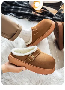 Detailed view of brown suede clogs featuring a thick sole and warm white plush lining