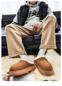 Close-up detail of men's thick-soled plush-lined clogs presented on a white fluffy rug