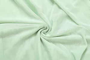 Gros plan détaillé sur la texture du tissu en maille vert menthe respirant pour été