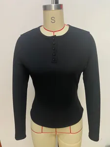 Macro view of black ribbed long-sleeve Henley shirt showing the buttoned neckline detail