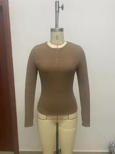 Close-up of brown ribbed long sleeve Henley T-shirt on a mannequin showing button detail