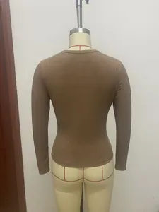 Rear view of a women's brown slim-fit rib-knit long-sleeve top on a mannequin.