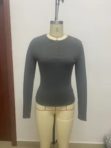 Detail view of the ribbed fabric and buttoned Henley neck on this slim-fit long sleeve top