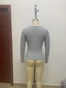Detailed back view of a grey women's slim fit ribbed long sleeve shirt on a mannequin