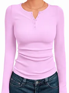 Detail view of pink ribbed Henley top with long sleeves and decorative button neckline