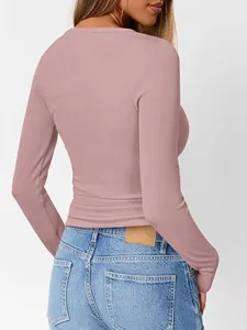 Detailed back view of a dusty pink long-sleeve slim fit ribbed T-shirt for women