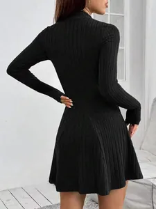 Back view of a long-sleeved black ribbed mini dress with a slim fit and A-line silhouette