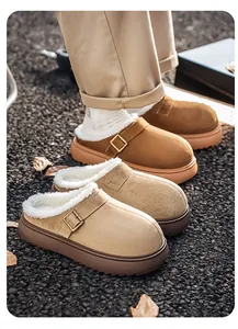 Detailed view of thick-soled men's winter mules with warm fleece lining on gravel