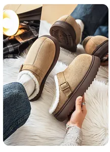 Close-up detail of warm fleece-lined khaki platform Birkenstock style clogs on a plush rug