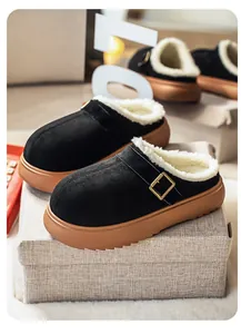 Detail view of stylish black suede platform clogs featuring warm white faux fur lining.