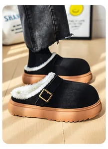 Close-up of black fleece-lined platform mules with buckle and tan soles.