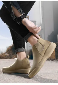Gedetailleerd zicht op kaki heren Chelsea-laarzen met dikke zool gedragen door een model