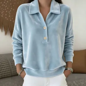 High quality detail of a light blue velvet shirt featuring a lapel and half-button closure