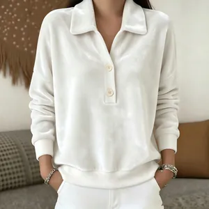 Detailed view of women's white velvet sweatshirt with buttoned polo collar