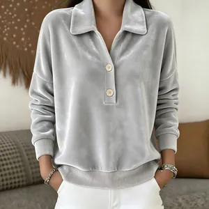 Detailed view of grey velvet polo shirt with half-placket buttons and ribbed cuffs