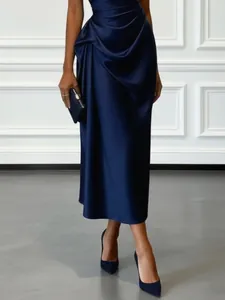 Detailed view of elegant navy blue satin evening dress with pleated drapes