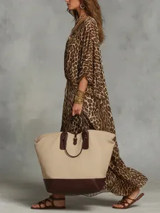 Side view of elegant leopard print maxi dress with cinched waist and flowy silhouette