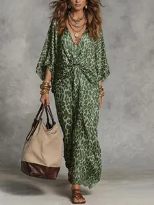 Elegant green leopard print V-neck maxi dress with knotted waist and gold accessories