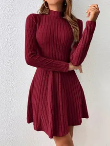 Detailed view of the elegant burgundy ribbed knit dress with a mock neck and slim fit