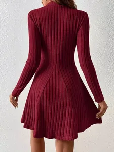 Back detail of a long sleeve burgundy ribbed knit A-line dress with a slim fit waistline