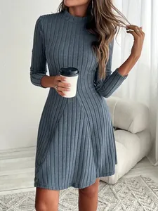 Close-up of a dusty blue ribbed long sleeve A-line dress with a mock neck and slim fit waist