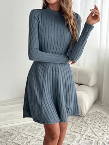 Close-up of blue ribbed knit mock-neck A-line dress with long sleeves on a model