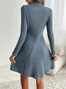 Detailed back view of a blue-grey ribbed knit long sleeve A-line dress with high neck