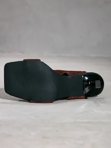Bottom view of brown suede high heel sandal showing anti-slip sole texture