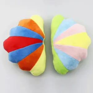 Juguetes de peluche para perros con forma de concha en colores arcoíris y pastel.