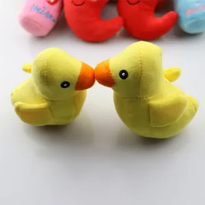 Two cute yellow squeaky plush duck toys for dogs and cats in a lovely kissing pose